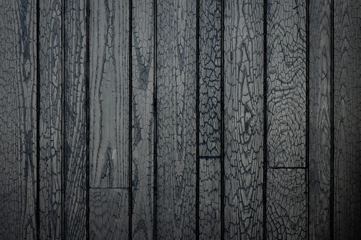 High-detail macro shot of black, charred timber planks with a cracked "alligator skin" texture. Displays the Shou Sugi Ban finish available for BAL-29 applications.