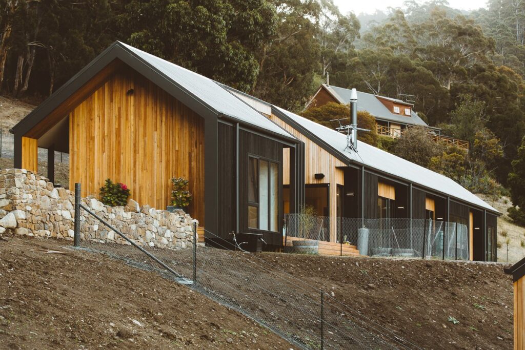 Tasmanian hillside home clad in Silvertop Ash Trendplank with Cutek Clear finish alongside charred Shou Sugi Ban timber